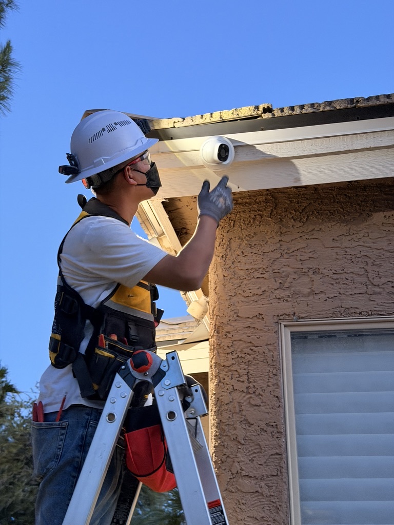 Technician installing an outdoor security camera